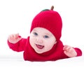 Funny laughing baby wearing knitted red apple hat