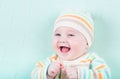 Funny laughing girl in a knitted sweater and hat o Royalty Free Stock Photo