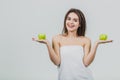 Funny laughing woman holding two green apples in her eyes. White background of a healthy eating concept. Diet Royalty Free Stock Photo
