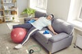 Funny, lazy, overweight woman sleeping on sofa instead of having fitness workout Royalty Free Stock Photo