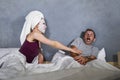 Funny lifestyle portrait of man and woman featuring weird married couple with wife in head towel and makeup face mask demanding se