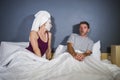 Funny lifestyle portrait of man and woman featuring weird married couple with wife in head towel and makeup face mask demanding se