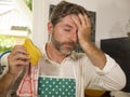 Funny lifestyle portrait of mid adult unhappy and stressed man in kitchen apron feeling frustrated and upset overwhelmed by