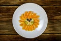 Funny lion face composition with fruits like orange blueberry on wooden table