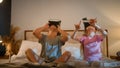 Funny little amazed caucasian children kids boy girl brother sister playing video game using digital virtual reality Royalty Free Stock Photo