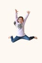 Funny little Asian child girl jumping and freedom movement on air isolated over white background. Happy kid with smiling shot. Royalty Free Stock Photo