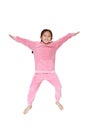 Funny little Asian child girl in pink tracksuit or sport cloth jumping on air over white background. Freedom kid movement concept Royalty Free Stock Photo