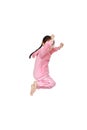 Funny little Asian child girl in pink tracksuit or sport cloth jumping on air over white background. Freedom kid movement concept Royalty Free Stock Photo