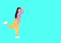 Funny little Asian child girl in pink-yellow dungarees jumping over cyan background with copy space. Freedom kid movement concept