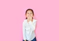 Funny little asian kid girl with expression pig face and hands isolated on pink background. Amusing playful child piggy