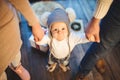 Funny little baby boy 1 year old learning walk home in winter in a decorated New Year house. Young family dad and mom hold by the Royalty Free Stock Photo