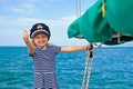 Funny little baby captain on board of sailing yacht Royalty Free Stock Photo