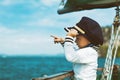 Funny little baby captain on board of sailing yacht