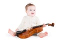 Funny little baby girl playing with a big violin Royalty Free Stock Photo