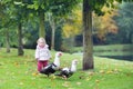 Funny little baby girl with wild ducks in autumn park Royalty Free Stock Photo