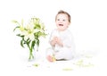 Funny little baby with lily flowers Royalty Free Stock Photo