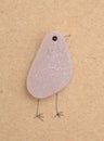 Funny little birds made of a piece of seaglass, with sketchily drawn legs and beak