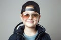 Funny little boy in glasses and cap. stylish smiling kid Royalty Free Stock Photo