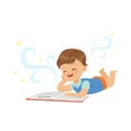 Funny little boy lying and reading magic book with fantasy stories. Interesting childhood and imagination concept Royalty Free Stock Photo