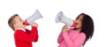 Funny little boy shouting through a megaphone to his friend. Royalty Free Stock Photo