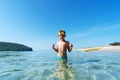 Funny little boy posing in sea beach water wearing goggles enjoying summer travel vacation Royalty Free Stock Photo