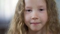 Funny little Caucasian girl looking to camera, childhood concept, face close-up Royalty Free Stock Photo