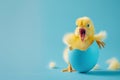 Funny little chick hatching from a blue egg. Vibrant Easter celebration banner greetings card poster