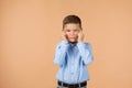 Funny little child boy in blue shirt making narrow eyes Royalty Free Stock Photo