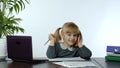 Funny little child girl boss manager emotionally talking on mobile phone, sitting at computer table Royalty Free Stock Photo