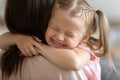 Funny cute little girl smiling embracing foster care parent mum