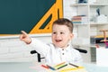Funny little child having fun on blackboard background. School concept. Royalty Free Stock Photo