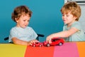 Funny little child having fun and play with toy car. Happy cute clever boy pupil at preschool. Cute child boy in Royalty Free Stock Photo