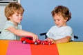 Funny little child having fun and play with toy car. Happy cute clever boy pupil at preschool. Cute child boy in Royalty Free Stock Photo