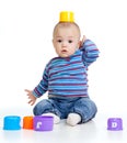 Funny little child is playing with cup toys