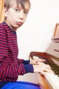 Funny little child playing piano Royalty Free Stock Photo