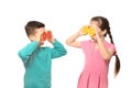 Funny little children with citrus fruits on white background