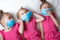 Funny Little children girls in medical masks. Global quarantine at home. Pandemic protection