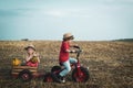 Funny little couple child riding on retro bicycle on sky background. Generation of people and stages of growing up.