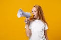 Funny little ginger kid girl 12-13 years old in white t-shirt isolated on bright yellow wall background children studio Royalty Free Stock Photo