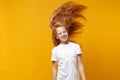 Funny little ginger kid girl 12-13 years old in white t-shirt isolated on yellow background children studio portrait Royalty Free Stock Photo