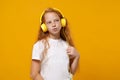 Funny little ginger kid girl 12-13 years old in white t-shirt isolated on yellow wall background children studio Royalty Free Stock Photo
