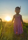 Funny little girl as indian with maracas and feather