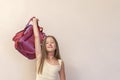 Funny little girl with big backpack jumping and having fun against white wall. School concept. Back to School. Celebrating the end Royalty Free Stock Photo