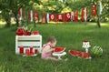 Funny little girl bites watermelon sitting on the grass. Royalty Free Stock Photo