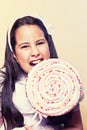 Little Girl Biting a Big Lollipop Royalty Free Stock Photo