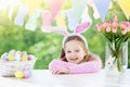 Funny little girl in bunny ears at breakfast Royalty Free Stock Photo