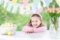 Funny little girl in bunny ears with Easter eggs Royalty Free Stock Photo