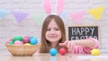 Funny little girl with bunny ears play Easter hare hunter at home Royalty Free Stock Photo