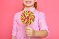 Funny little girl with candy lollipop. Happy little girl holding a candy. Royalty Free Stock Photo