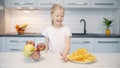 Little girl chooses food in the kitchen Royalty Free Stock Photo